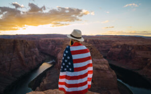 A man with the American flag wrapped around