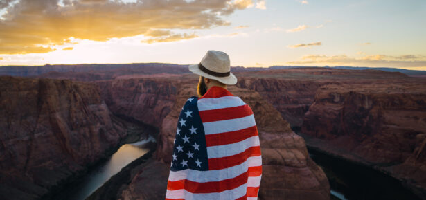 A man with the American flag wrapped around