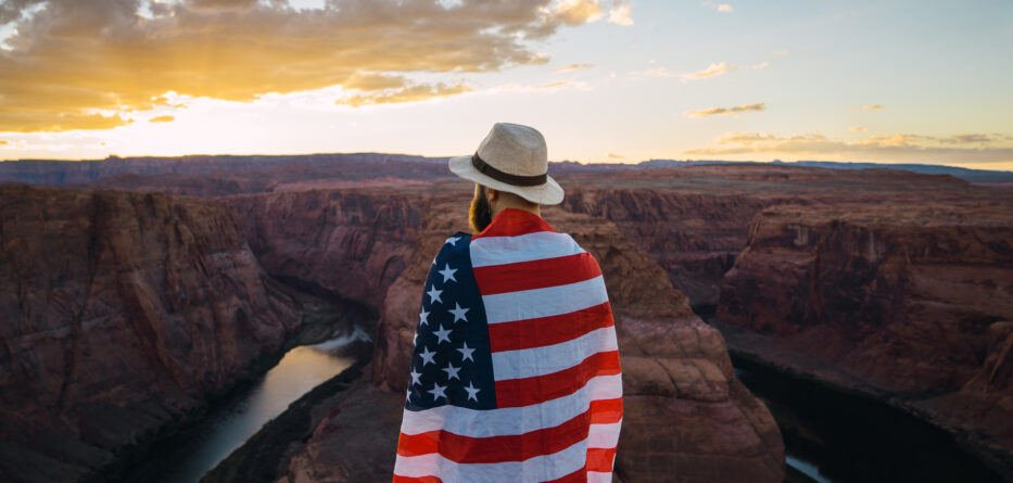 A man with the American flag wrapped around